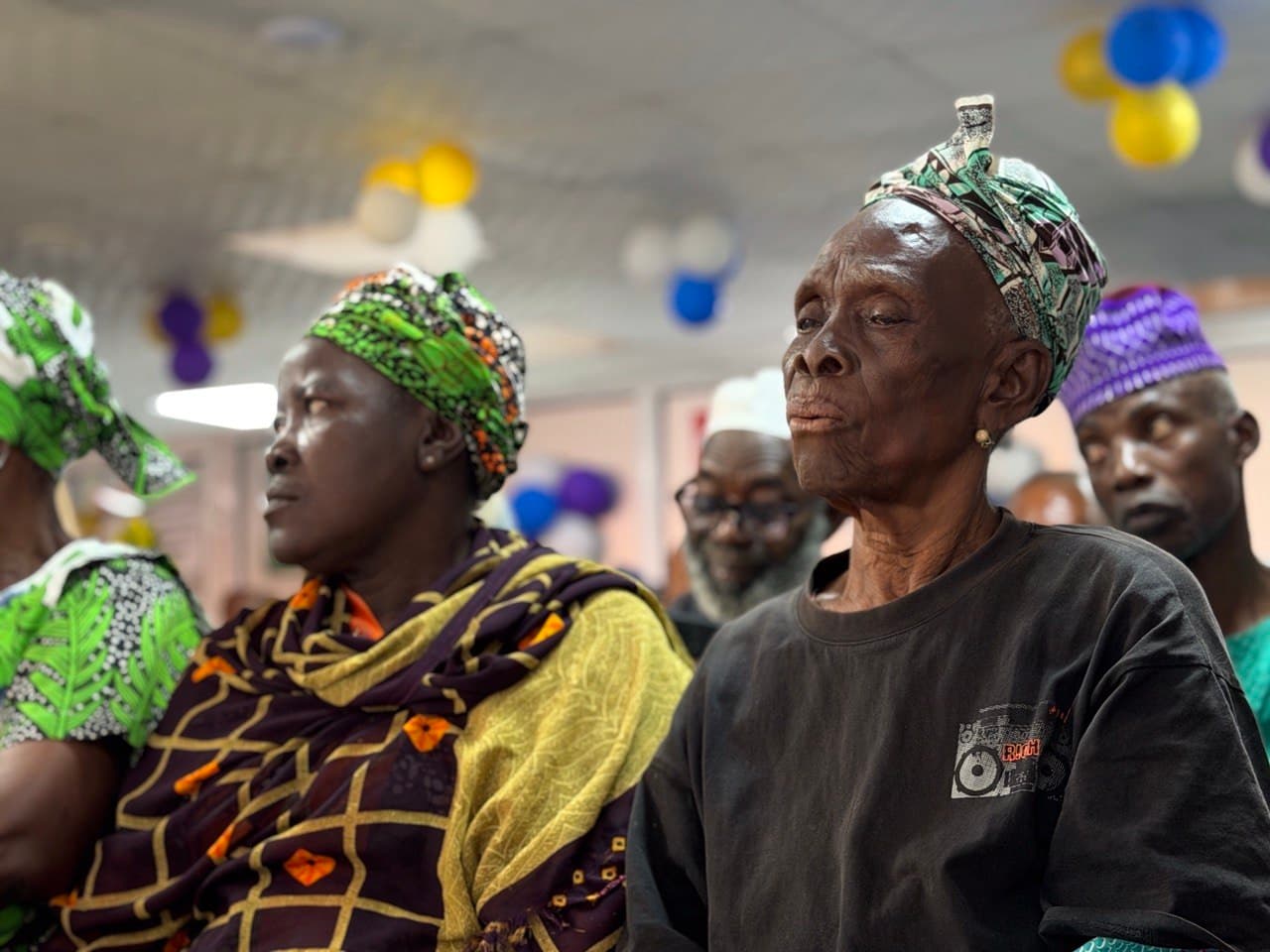 A healthcare worker checking the blood pressure of an elderly woman