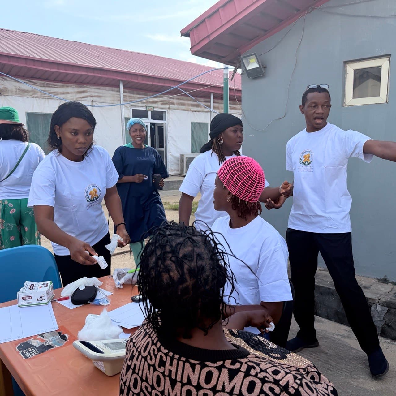 A volunteer guiding children during an outdoor community activity